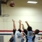port--A young boy attempts to block a shot by another boy in an Upward basketball game.